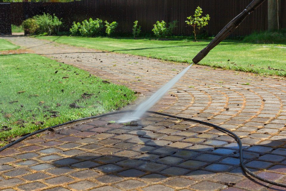 Pressure washing brick pathway